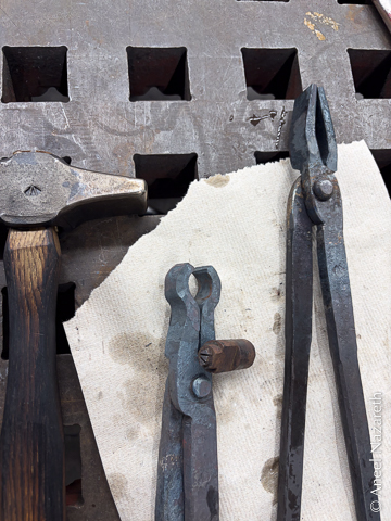 The hammer, round tongs, touchmark, and flat tongs