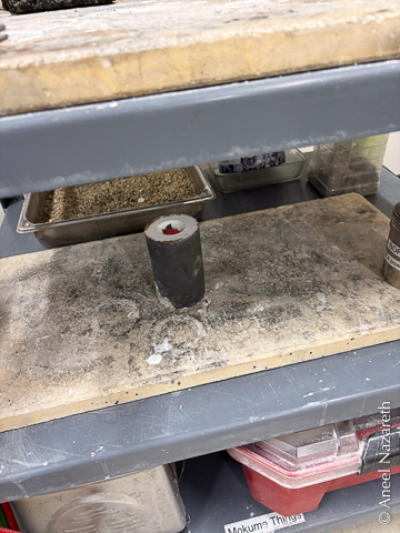 The flask is cooling on a shelf. You can see that the metal in it is still a dull red
