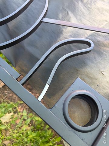 A short section of a tentacle has had the mask peeled off. It's bright and shiny, while the rest is matte black