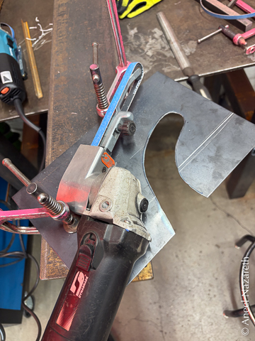 A dynafile, which is a handheld mini belt grinder, on the sheet