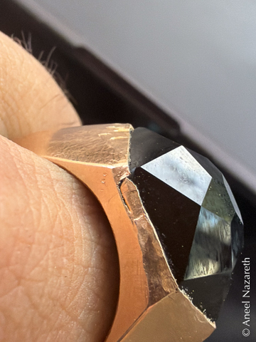 A closeup of the back of the ring showing a crack in the bezel